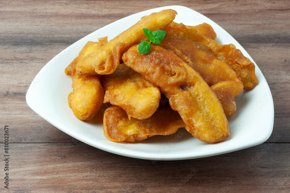 Close up of pisang goreng or banana fritters on a plate Close up of pisang goreng or banana fritters on a plate