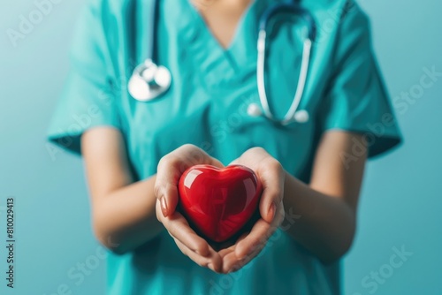 A nurse holding a red heart. Suitable for medical and healthcare concepts