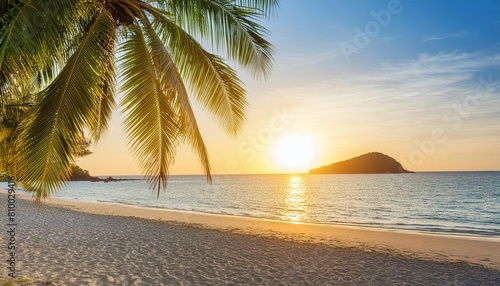 Tropical beach with palm trees during sunset 