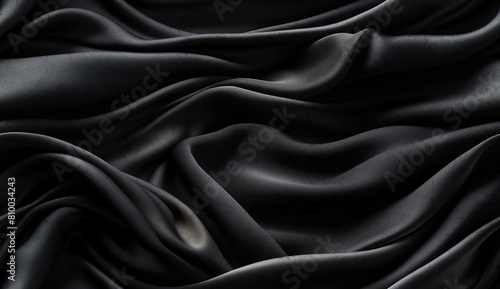 Fondo negro lujoso, el tejido se extiende en suaves ondas. Gasa, satén y material brillante. vista superior. pliegues de tela ligera. fondo de boda y de lujo. photo