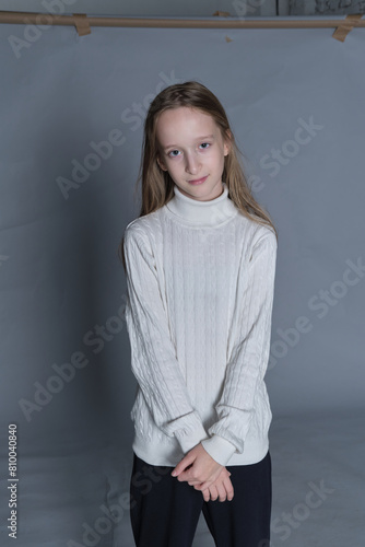 Youthful grace in a soft turtleneck, her stance relaxed yet confident. Perfect for portraying natural elegance in young fashion.