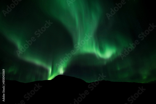 Green northern lights or the aurora borealis oven hills above Abisko National Park, Sweden © raathlive