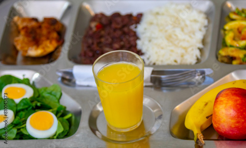 Typical steel tray with nutritious rustic food. Traditional university and popular tray