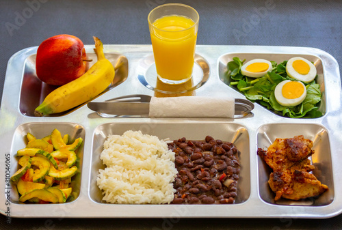 Typical steel tray with nutritious rustic food. Traditional university and popular tray