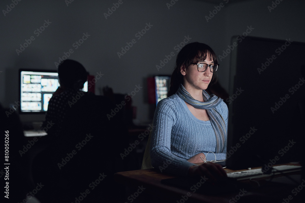 Dark, office and woman at computer for data analysis, online programming and cybersecurity. Software, research and web developer in coworking space for cyber hacking, firewall and malware coding