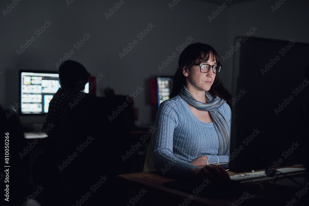 Dark, office and woman at computer for data analysis, online programming and cybersecurity. Software, research and web developer in coworking space for cyber hacking, firewall and malware coding Dark, office and woman at computer for data analysis, online programming and cybersecurity. Software, research and web developer in coworking space for cyber hacking, firewall and malware coding