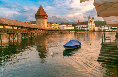 Twilight view of historic Chapel Bridge and Water Tower in Lucerne, Switzerland