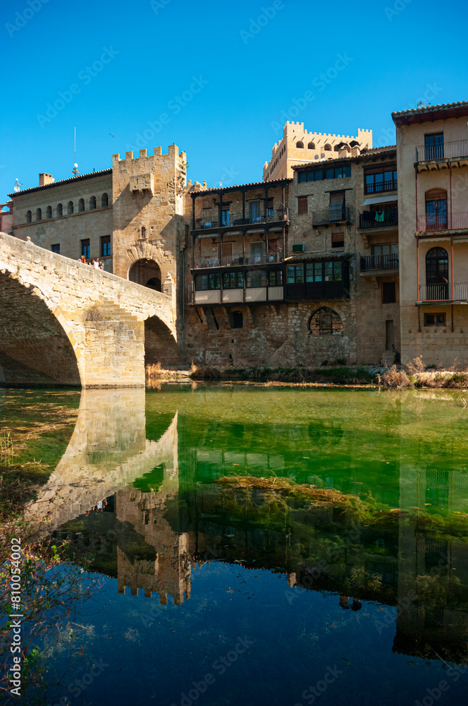 Reflection in the Matarraña River as it passes through the medieval town of Valderrobres. Teruel Spain.