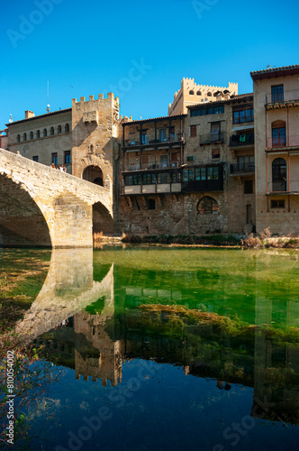 Reflection in the Matarra  a River as it passes through the medieval town of Valderrobres. Teruel Spain.