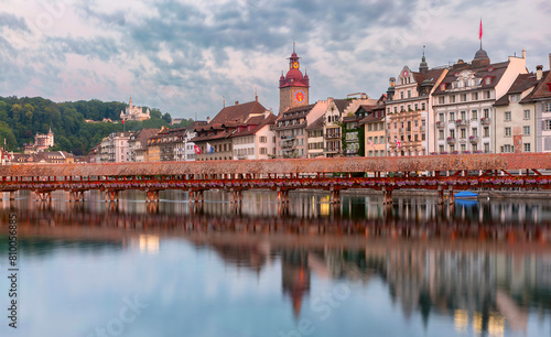 Evening view of Chapel Bridge with floral adornments in Lucerne, Switzerland