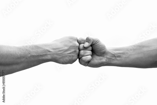 Fist Bump. Clash of two fists, vs. Gesture of giving respect or approval. Friends greeting. Teamwork and friendship. Partnership concept. Male athletes fist bumping against. Black and white photo