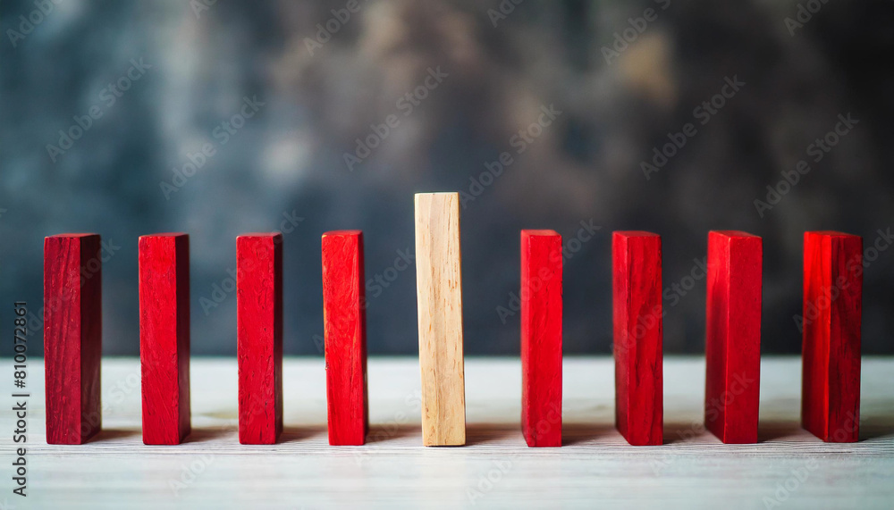 red wooden block halts cascading domino effect, concept of disruption and uniqueness red wooden block halts cascading domino effect, concept of disruption and uniqueness