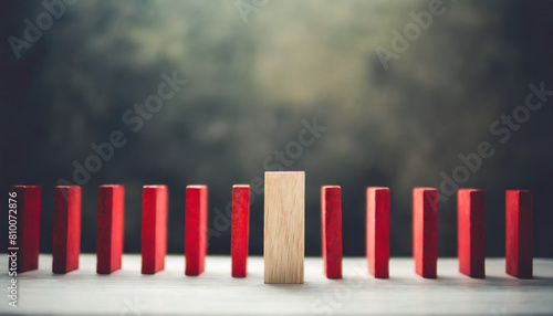 red wooden block halts cascading domino effect, concept of disruption and uniqueness
