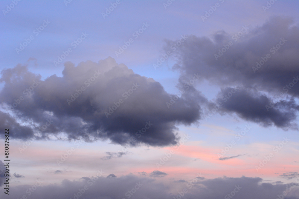 a sunset sky with grey clouds and pink and purple clouds a sunset sky with grey clouds and pink and purple clouds