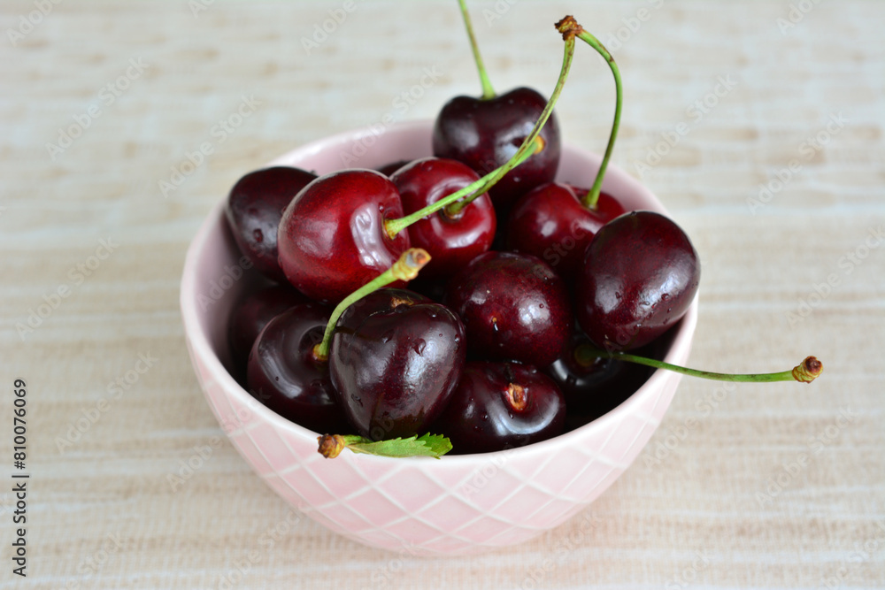 a bowl of sweet cherries with water drops close up a bowl of sweet cherries with water drops close up