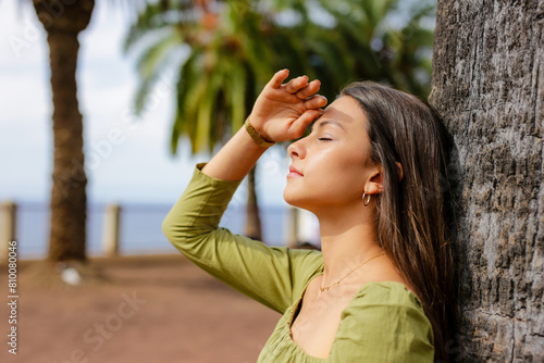 Young woman protecting herself from sun's rays on summer day. Healthy Lifestyle Concept