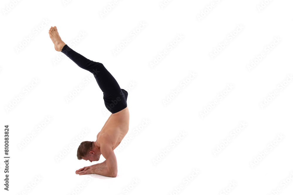 A young attractive man with an athletic body is doing fitness. White background.