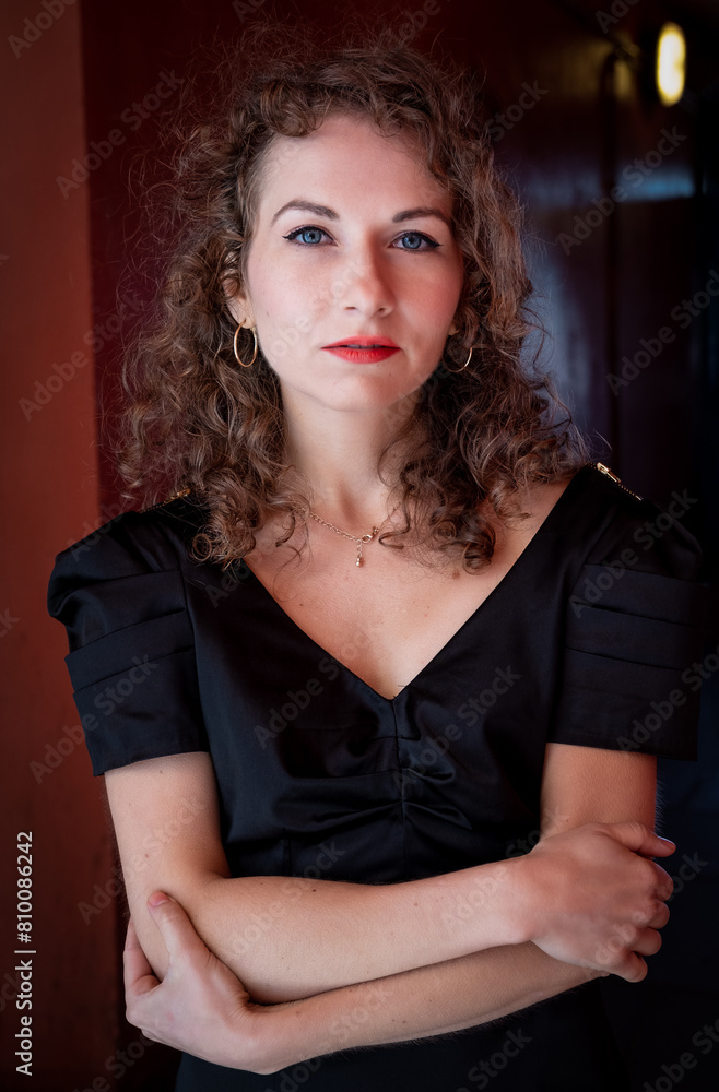 Confident woman looking at camera in a corridor.