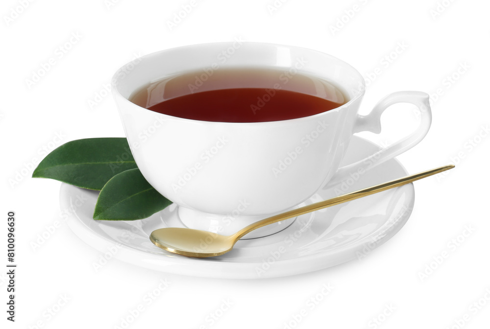 Aromatic tea in cup, golden spoon and green leaves isolated on white Aromatic tea in cup, golden spoon and green leaves isolated on white