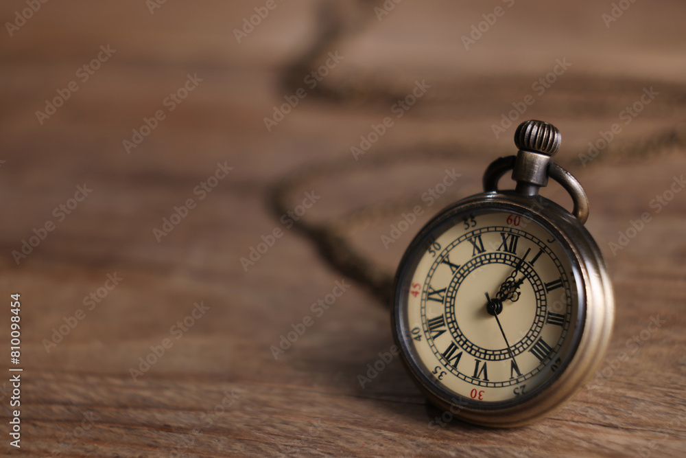 Pocket clock on wooden table, closeup. Space for text Pocket clock on wooden table, closeup. Space for text