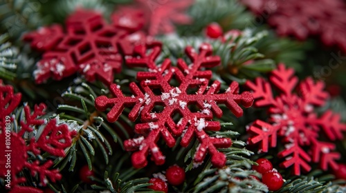   A pile of green leaves and pine needles topped with red and white snowflakes