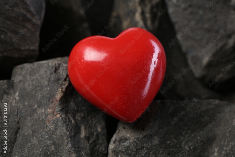 Obraz premium One red decorative heart on stones, closeup
