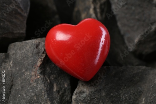 One red decorative heart on stones  closeup