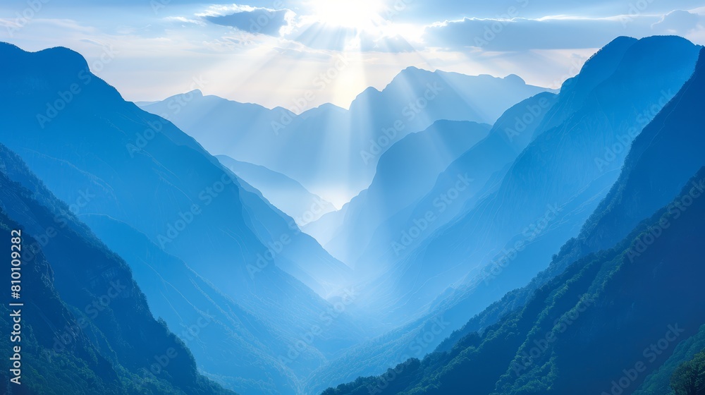 Mountains background, sun shines through clouded sky Mountains background, sun shines through clouded sky