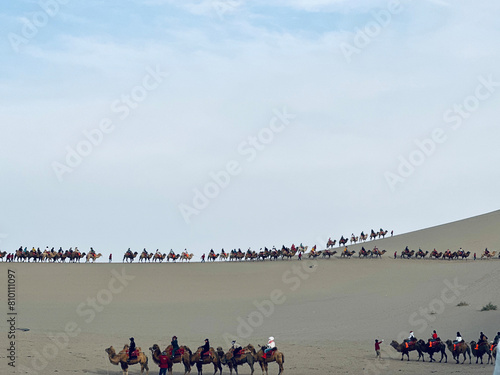 group of people riding camels