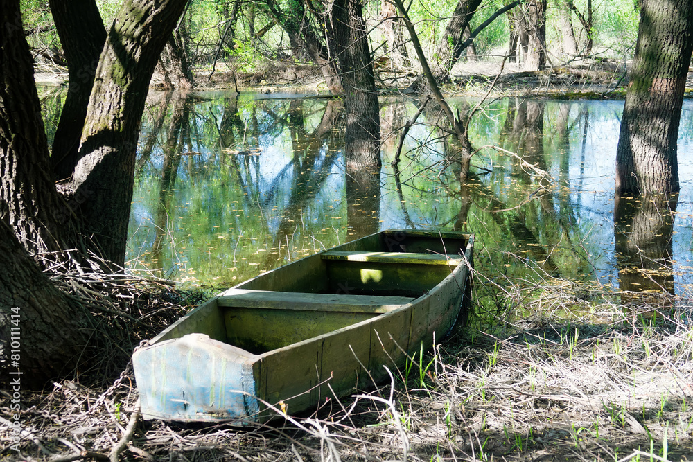 Old style boat, primitive box-shaped wooden boat for sailing in small inland reservoirs on the banks of the dead arm of river and floodplain forest. Don River. Russia
