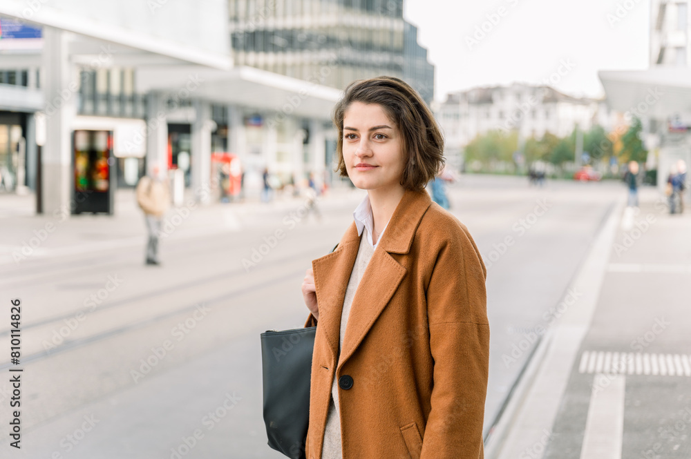 Fototapeta premium Elegant young woman waiting patiently the bus