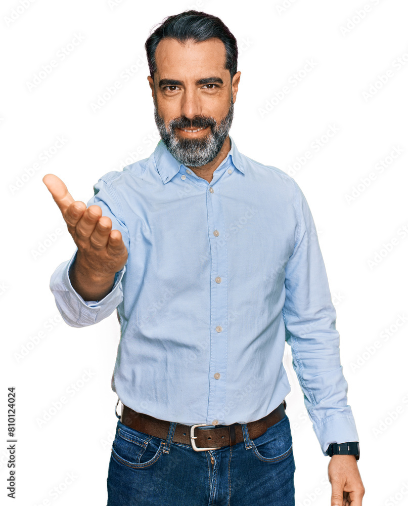 Middle aged man with beard wearing business shirt smiling friendly offering handshake as greeting and welcoming. successful business. Middle aged man with beard wearing business shirt smiling friendly offering handshake as greeting and welcoming. successful business.