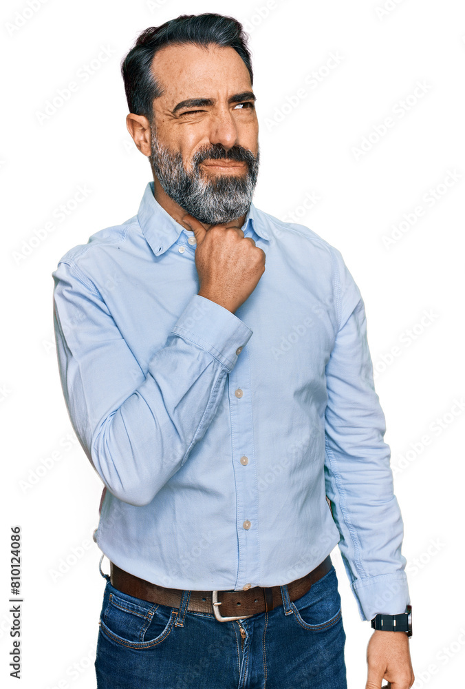 Middle aged man with beard wearing business shirt touching painful neck, sore throat for flu, clod and infection Middle aged man with beard wearing business shirt touching painful neck, sore throat for flu, clod and infection