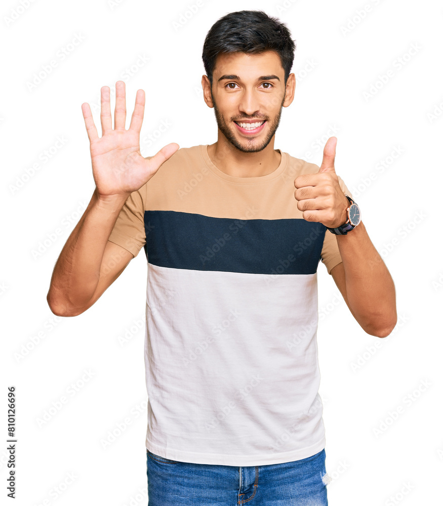Fototapeta premium Young handsome man wearing casual clothes showing and pointing up with fingers number six while smiling confident and happy.
