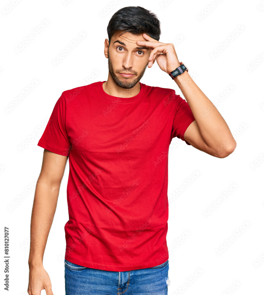 Young handsome man wearing casual red tshirt worried and stressed about a problem with hand on forehead, nervous and anxious for crisis Young handsome man wearing casual red tshirt worried and stressed about a problem with hand on forehead, nervous and anxious for crisis