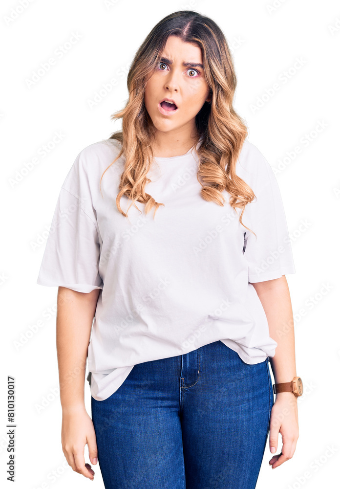 Young caucasian woman wearing casual clothes in shock face, looking skeptical and sarcastic, surprised with open mouth Young caucasian woman wearing casual clothes in shock face, looking skeptical and sarcastic, surprised with open mouth