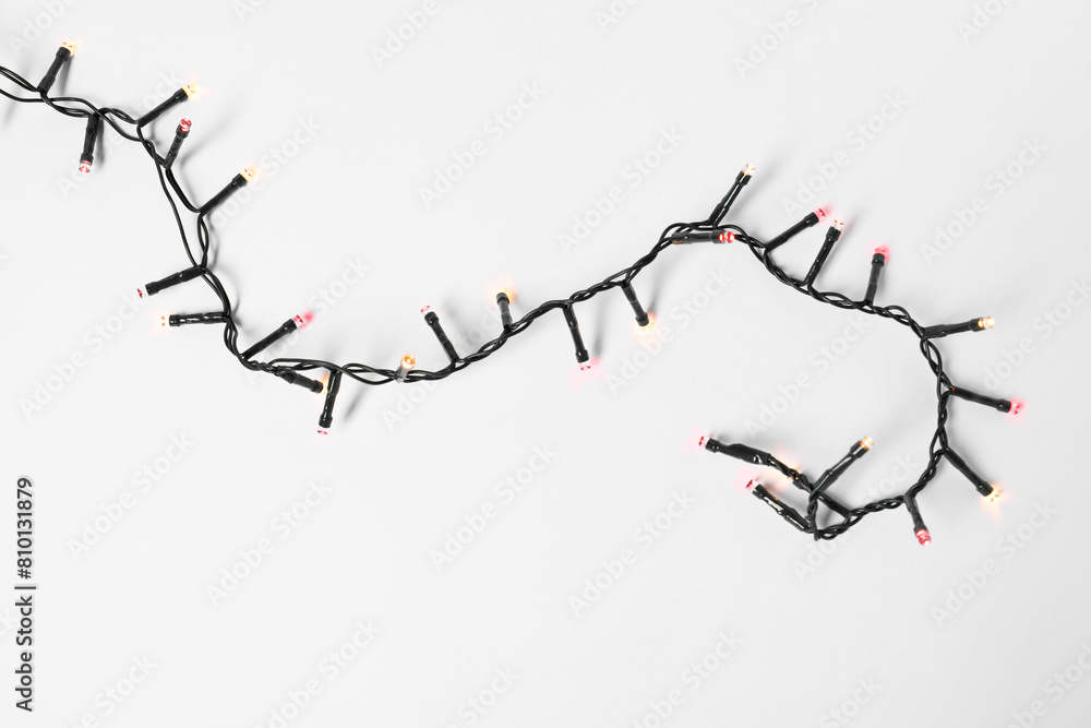 Naklejka premium Beautiful Christmas lights on white background, top view