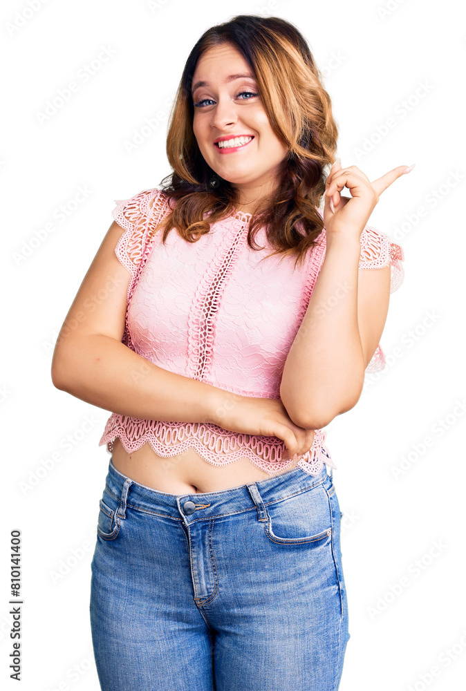 Young beautiful caucasian woman wearing casual clothes with a big smile on face, pointing with hand and finger to the side looking at the camera. Young beautiful caucasian woman wearing casual clothes with a big smile on face, pointing with hand and finger to the side looking at the camera.