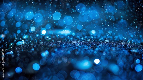  a blue backdrop dotted with numerous water droplets on its surface