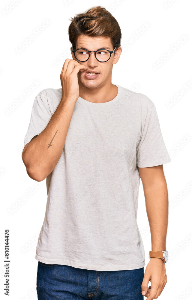 Handsome caucasian man wearing casual clothes and glasses looking stressed and nervous with hands on mouth biting nails. anxiety problem. Handsome caucasian man wearing casual clothes and glasses looking stressed and nervous with hands on mouth biting nails. anxiety problem.