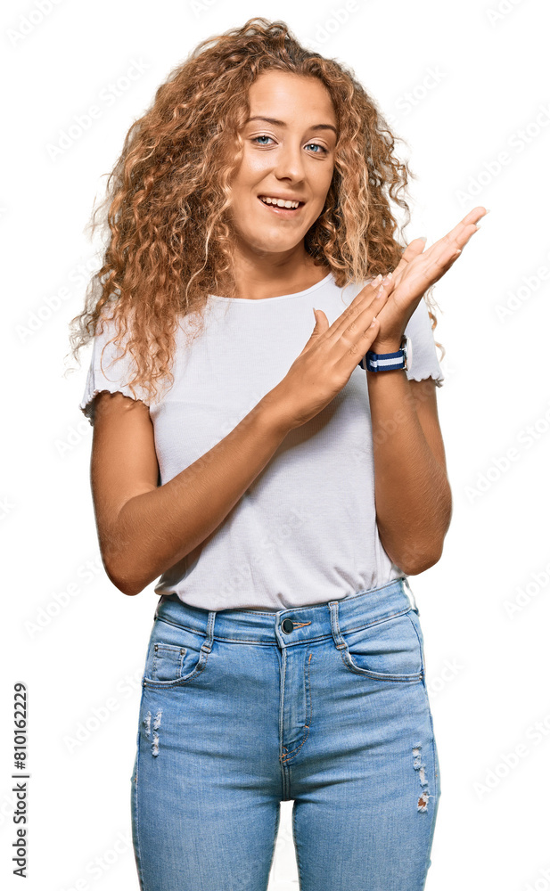 Beautiful caucasian teenager girl wearing casual white tshirt clapping and applauding happy and joyful, smiling proud hands together