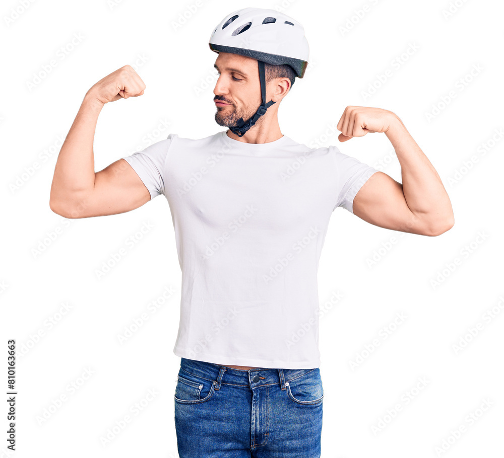 Young handsome man wearing bike helmet showing arms muscles smiling proud. fitness concept. Young handsome man wearing bike helmet showing arms muscles smiling proud. fitness concept.