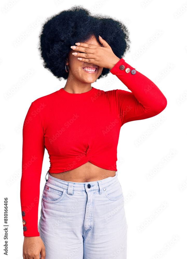 Young african american girl wearing casual clothes and glasses smiling and laughing with hand on face covering eyes for surprise. blind concept. Young african american girl wearing casual clothes and glasses smiling and laughing with hand on face covering eyes for surprise. blind concept.