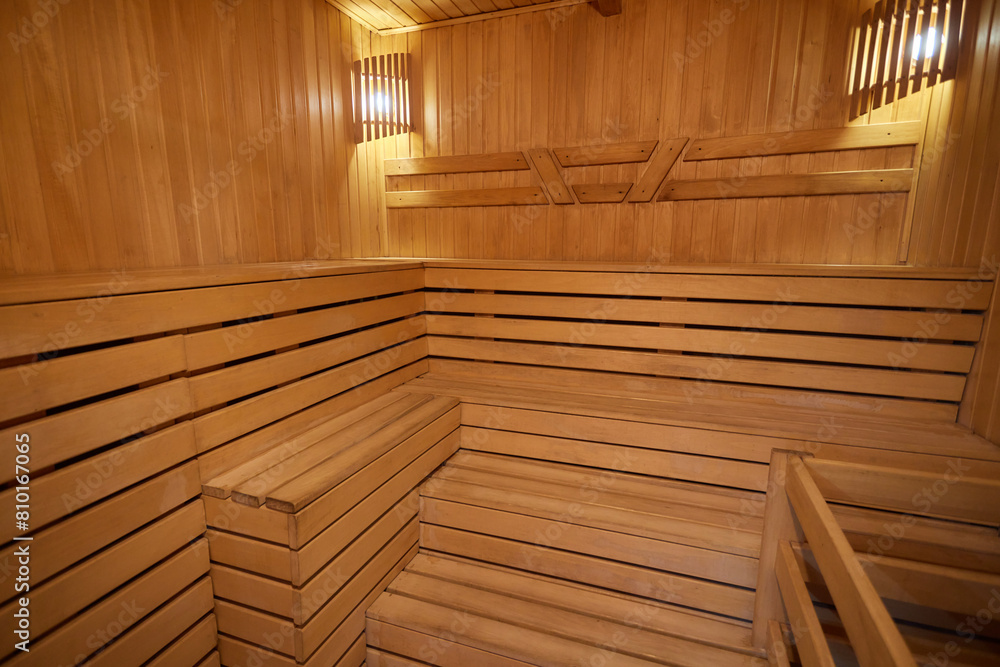 A hardwood sauna with a plank ceiling, brick wall, and stairs A hardwood sauna with a plank ceiling, brick wall, and stairs