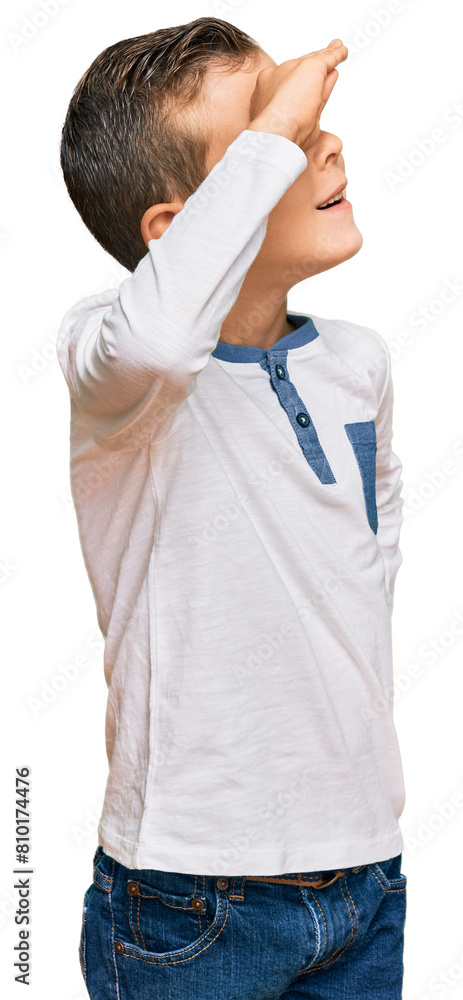 Adorable caucasian kid wearing casual clothes very happy and smiling looking far away with hand over head. searching concept. Adorable caucasian kid wearing casual clothes very happy and smiling looking far away with hand over head. searching concept.