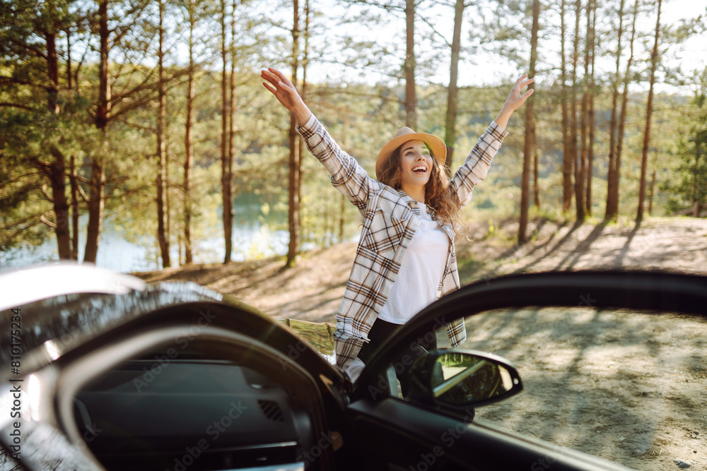 Young woman enjoying and having fun in their vacations outdoors leaning out car window. Summer trip. Young woman enjoying and having fun in their vacations outdoors leaning out car window. Summer trip.