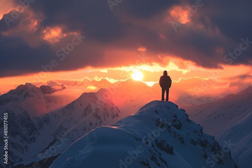 Lone figure silhouetted snow-covered peaks witnessing beauty mountain sunset