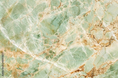 High-resolution image showcasing the intricate patterns of green and gold in natural marble stone, perfect for luxurious background design or as a sophisticated texture overlay