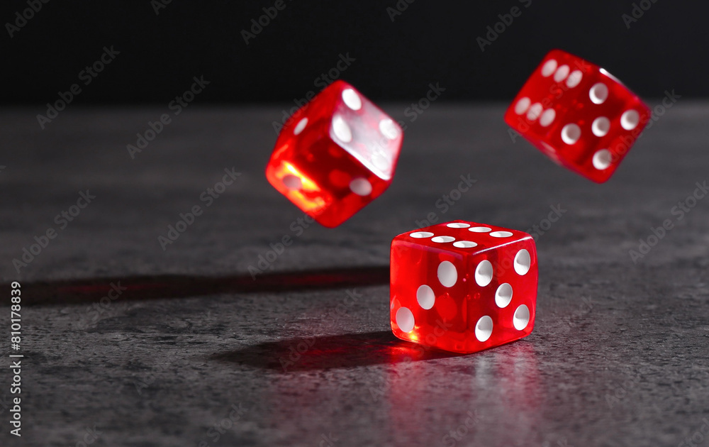 Many red game dices falling on grey textured table Many red game dices falling on grey textured table