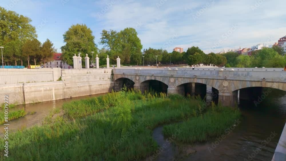 Manzanares River with one of the old bridges that crosses the river in the city of Madrid. Manzanares River with one of the old bridges that crosses the river in the city of Madrid.